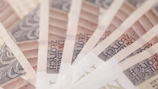Rotating spread of two hundred zloty banknotes in macro composition seamless loop