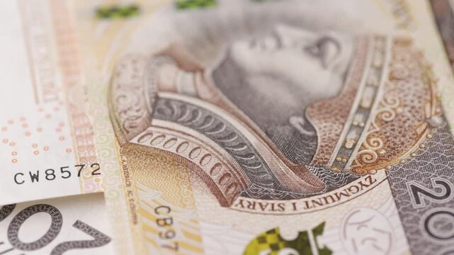 Macro rotation of overlapping two hundred zloty banknotes showing fine texture seamless loop