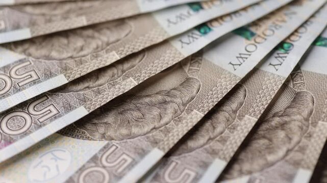 Macro rotation of aligned five hundred zloty banknotes forming fan layout seamless loop