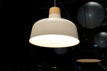 Modern Minimalist Pendant Lamp with Wooden Top Glowing in Dark. interior design, home decor, lighting technology, minimalism, scandinavian style, and ambient lighting for contemporary spaces.