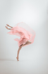 A fragile girl dances in a ballet outfit.