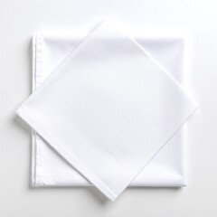 A pristine white napkin elegantly displays two neatly folded sheets, showcasing a crisp texture and a subtle sheen, perfect for a formal dining setting.