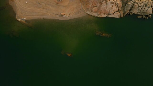 Drone hovering above Almendra Reservoir water surface in Spain