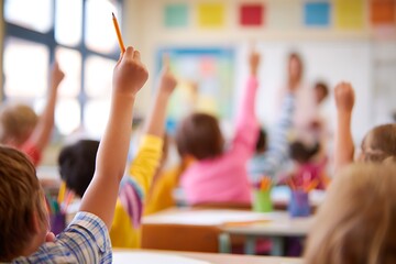 Young children with hands raised in classroom. Elementary student education and learning environment. Back to school concept for primary kids.