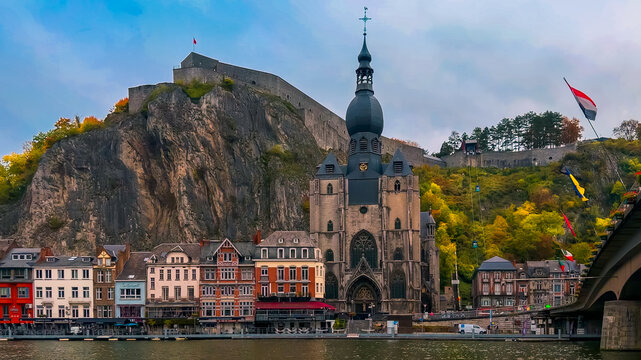 Medieval church and fortress perched on a cliff overlooking a river in the birthplace of the saxophone, Dinant, Belgium, October 13, 2025