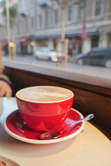 Coffee cup on table near window in busy street setting