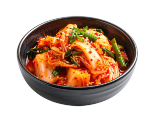 Spicy kimchi in a black bowl, garnished with green onions and sesame seeds on a white background