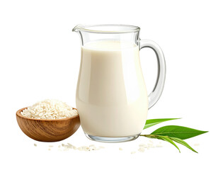 Creamy rice milk in a glass pitcher with rice grains and green leaves