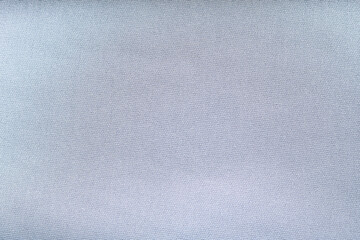 A soft, light textile with a subtle, interwoven diagonal pattern. The fine, uniform ribbing creates a clean, muted, and versatile fabric background texture, often used for apparel or home goods.