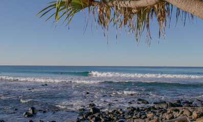 a surfer riding a wave on a beautiful sunny winter's afternoon at burleigh heads in queensland, australia