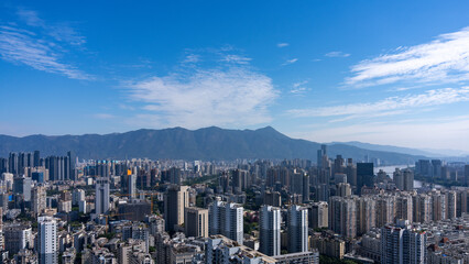 Obraz premium Urban Skyline with Skyscrapers and Mountains