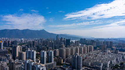 Fototapeta premium Urban Skyline with Modern Skyscrapers and Mountains