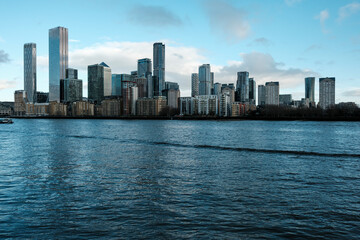 Canary wharf cityscape reflecting on river thames water