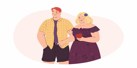 A loving couple stands closely together holding hands and smiling gently