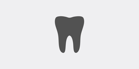 A simple illustration of a dark gray tooth on a light gray background