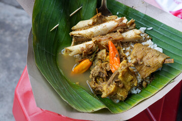 Indonesian goat soup typical of Surakarta, Java. Goat bones are cooked in a thin coconut milk-based broth enriched with various spices and herbs.