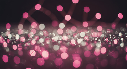 Glittering pink and silver bokeh lights on dark background
