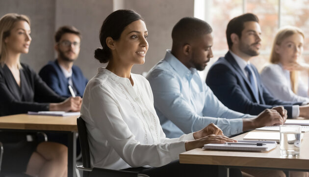 Diverse group of professionals attending a meeting or seminar in a conference room. - Powered by Adobe