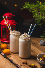 Glasses of butterbeer with a cap of whipped cream