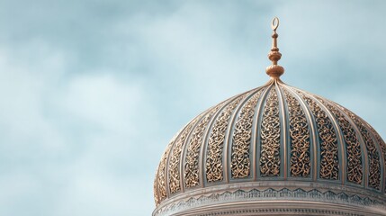 Close up view of an ornate Islamic mosque dome with intricate gold patterns against a soft blue sky