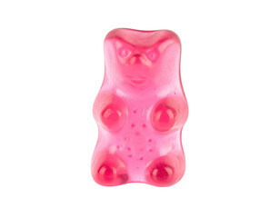 A close-up of a bright pink, translucent gummy bear against black