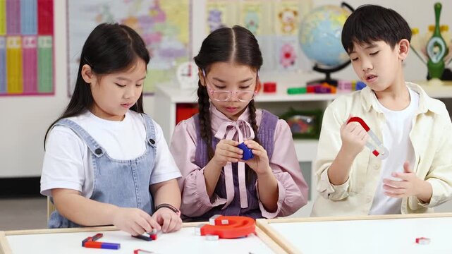 School Children Conduct Magnet Science Experiment Together in Classroom