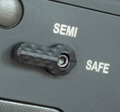 Macro shot of  an assault rifle that has its safety engaged