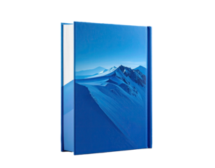 Book with blue cover showing snowy mountains against a clear sky