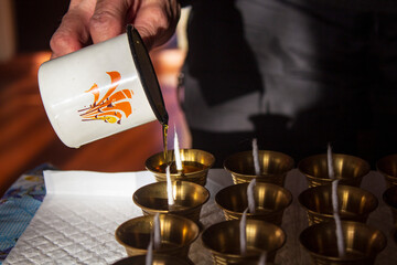 Buddhist Altar Candles at Religious 108 Butter Lamp Festival in Temple Monastery. Pouring Melted Butter Oil. Preparation process