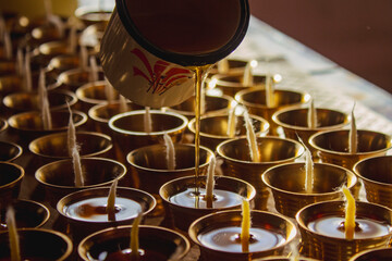 Buddhist Altar Candles at Religious 108 Butter Lamp Festival in Temple Monastery. Pouring Melted Butter Oil. Preparation process