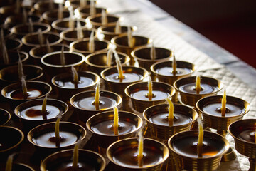 Buddhist Altar Candles at Religious 108 Butter Lamp Festival in Temple Monastery. Pouring Melted Butter Oil. Preparation process