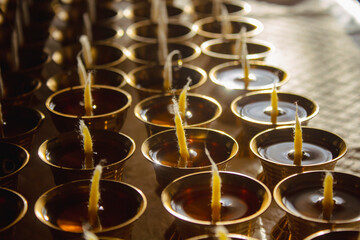 Buddhist Altar Candles at Religious 108 Butter Lamp Festival in Temple Monastery. Pouring Melted Butter Oil. Preparation process