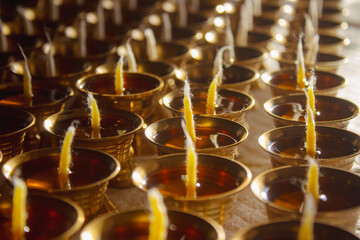 Buddhist Altar Candles at Religious 108 Butter Lamp Festival in Temple Monastery. Pouring Melted Butter Oil. Preparation process