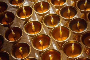 Buddhist Altar Candles at Religious 108 Butter Lamp Festival in Temple Monastery. Pouring Melted Butter Oil. Preparation process
