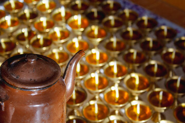 Buddhist Altar Candles at Religious 108 Butter Lamp Festival in Temple Monastery. Pouring Melted Butter Oil. Preparation process