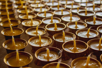 Buddhist Altar Candles at Religious 108 Butter Lamp Festival in Temple Monastery. Pouring Melted Butter Oil. Preparation process