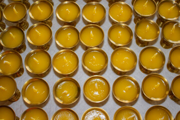 Buddhist Altar Candles at Religious 108 Butter Lamp Festival in Temple Monastery. Pouring Melted Butter Oil. Preparation process