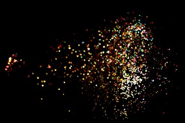 Multicolored glitter constellation drifting on black night sky, magical sparkling confetti dust texture for cosmic celebration themes, party invitations, posters and dreamy digital artwork   © Marina