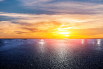 Wet asphalt road and beautiful sky clouds at sunset