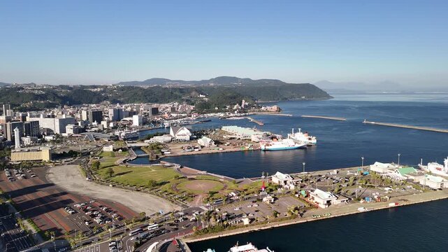 Kagoshima City, Kagoshima Prefecture, Kyushu Island, Japan &ndash; 4K Footage of Seaside City, Urban Streets, Towers, Skylines, Vehicles, Ferries, Sea Port and Sakurajima Volcano in Distance