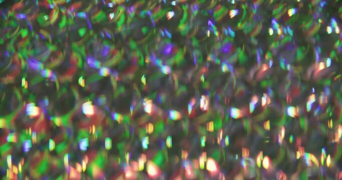 Glow rainbow. Colorful light. Defocused purple green pink round reflection gleam bright texture leak on abstract dazzle background.