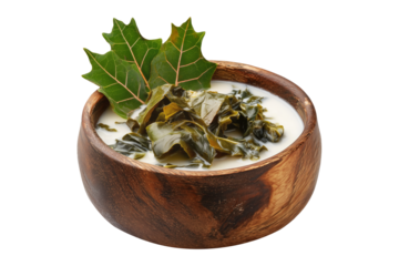 Rourou cooked taro leaves in creamy coconut milk, served in wooden bowl with garnishes, isolated on white transparent background, concept of Fiji cuisine