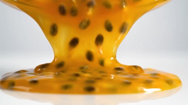  orange juice splash pouring into a glass on a yellow plate with decorative food icons like cheese and chocolate snacks