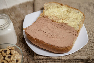 Bread with choco powder and butter on a plate for breakfast	
