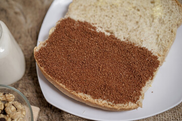 Bread with peanut and butter spread on a table for breakfast	