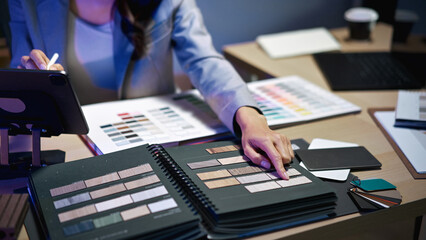 interior designer working on new house project in office. choosing materials and colors from samples