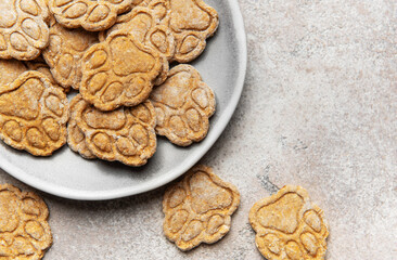 Homemade paw print dog treats on a plate