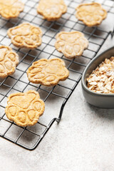 Homemade dog treats baking on cooling rack with oats