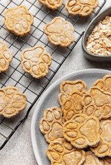 Homemade paw print dog treats cooling on rack