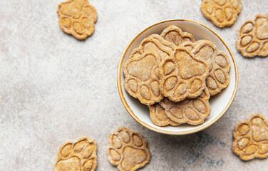 Homemade paw print dog treats in a bowl